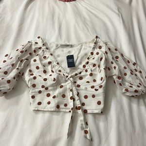 White with brown polka dot crop top. Quarter length sleeves.